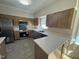 Spacious kitchen featuring stainless steel appliances, light wood cabinets, and quartz countertops at 208 Lawrence Rd, Cary, NC 27511