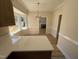 View of the kitchen featuring quartz countertops and a window to the backyard at 208 Lawrence Rd, Cary, NC 27511