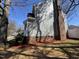 View of the side of the home showcasing the brick foundation and landscaping at 208 Lawrence Rd, Cary, NC 27511