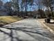 Residential street lined with mature trees, featuring well-maintained homes with manicured lawns at 208 Lawrence Rd, Cary, NC 27511