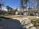 Neighborhood street view with well-kept lawns, mature trees, and neighboring homes at 208 Lawrence Rd, Cary, NC 27511