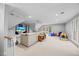 Expansive living room with neutral tones, comfortable seating, and natural light from large windows at 2104 Millpine Dr, Raleigh, NC 27614