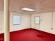 Finished basement with painted white cinder block walls, carpeted floors, and a small window at 2118 N Woodland Rd, Henderson, NC 27536