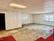Partially finished basement with a drop ceiling, one window, and a white painted cinder block wall at 2118 N Woodland Rd, Henderson, NC 27536