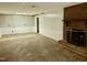 Unfinished basement with brick fireplace, wainscotting, and an open door to another room at 2118 N Woodland Rd, Henderson, NC 27536