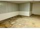 Unfinished basement space showing wood paneling and concrete floor, awaiting personalization at 2118 N Woodland Rd, Henderson, NC 27536