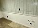 Unfinished basement with wood paneling, wainscoting, and hookups for a sink or other water-based appliance at 2118 N Woodland Rd, Henderson, NC 27536