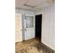 Unfinished basement with a drop ceiling, wood paneled walls, and an open door to another room at 2118 N Woodland Rd, Henderson, NC 27536