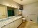 Bathroom with patterned wallpaper, a vanity, and a shower-tub combo at 2118 N Woodland Rd, Henderson, NC 27536