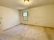 Neutral bedroom with a window, awaiting your personal touch at 2118 N Woodland Rd, Henderson, NC 27536