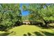 Charming brick ranch-style home with a well-manicured lawn and mature trees offering shade and curb appeal at 2118 N Woodland Rd, Henderson, NC 27536
