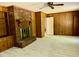 Cozy living room features a brick fireplace and wood paneling accents throughout at 2118 N Woodland Rd, Henderson, NC 27536
