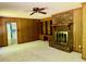 Inviting living room boasts a brick fireplace and convenient built-in shelving at 2118 N Woodland Rd, Henderson, NC 27536
