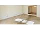 The vacant living room offers potential with neutral walls, carpet, and a view of the dining room through the doorway at 2118 N Woodland Rd, Henderson, NC 27536