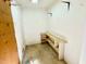 Small storage room with a pegboard and built in shelves at 2118 N Woodland Rd, Henderson, NC 27536