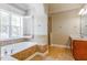 Elegant bathroom featuring a soaking tub, tiled floors, a vanity and a separate shower at 215 Oak Island Ct, Garner, NC 27529