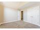 Bright bedroom featuring neutral walls, plush carpeting, and convenient closet space at 215 Oak Island Ct, Garner, NC 27529