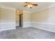 Spacious bedroom with neutral paint, crown molding, carpeting and a ceiling fan at 215 Oak Island Ct, Garner, NC 27529