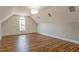 Bright bonus room featuring unique walls, hardwood style floors, and vaulted ceilings at 215 Oak Island Ct, Garner, NC 27529