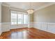 Elegant dining room with hardwood floors, decorative molding, and large windows at 215 Oak Island Ct, Garner, NC 27529