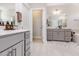 Bathroom featuring gray cabinetry, a soaking tub, and a glass-enclosed shower at 2212 Jollay St, Durham, NC 27703