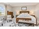 Bedroom featuring a window for natural light and wood bed frame with white linens at 2212 Jollay St, Durham, NC 27703