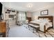Bright bedroom featuring a wood bed frame, decorative rug, and cozy sitting area at 2212 Jollay St, Durham, NC 27703
