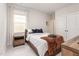 Cozy bedroom with natural light, a comfortable bed, and stylish wooden nightstand at 2212 Jollay St, Durham, NC 27703