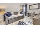 Stylish bedroom with a gray daybed, decorative pillows, and a modern bookcase at 2212 Jollay St, Durham, NC 27703