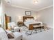 A naturally lit bedroom featuring a decorative rug and wood bed frame with white linens at 2212 Jollay St, Durham, NC 27703