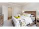 Cozy bedroom with a wooden bed frame, neutral-colored walls, and a window for natural light with ensuite entry at 2212 Jollay St, Durham, NC 27703