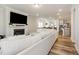 Open-concept living room with fireplace, TV, and clear sightlines into the kitchen and dining areas at 2212 Jollay St, Durham, NC 27703