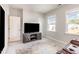 Media room featuring a comfortable reclining couch, a modern TV, and ample natural light at 2212 Jollay St, Durham, NC 27703