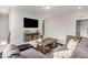 Inviting living space featuring a large sofa, media center with a TV, and a modern area rug at 2212 Jollay St, Durham, NC 27703