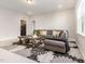 Comfortable living area with gray sofa, wooden coffee table, and stylish floral area rug at 2212 Jollay St, Durham, NC 27703