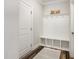Functional mud room with built-in bench, storage cubbies, coat hooks and a neutral rug at 2212 Jollay St, Durham, NC 27703