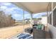 Covered patio featuring comfortable seating and view of the backyard and neighborhood at 2212 Jollay St, Durham, NC 27703