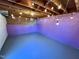 Finished basement with exposed rafters and lighting at 2409 Shenandoah Ave, Durham, NC 27704