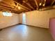 View of unfinished basement with painted cinder block walls and exterior access at 2409 Shenandoah Ave, Durham, NC 27704