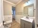 Bathroom showcases updated vanity, new light fixture and commode at 2409 Shenandoah Ave, Durham, NC 27704