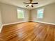 Bright bedroom features hardwood floors, two windows and a ceiling fan at 2409 Shenandoah Ave, Durham, NC 27704