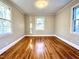 Bedroom features hardwood floors and multiple windows offering lots of light at 2409 Shenandoah Ave, Durham, NC 27704