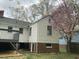 View of back of home featuring vinyl siding, brick foundation and deck at 2409 Shenandoah Ave, Durham, NC 27704