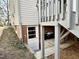 Basement walk-out door and deck supports on back of house at 2409 Shenandoah Ave, Durham, NC 27704