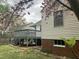 Rear view of home featuring a deck, white siding and brick foundation at 2409 Shenandoah Ave, Durham, NC 27704