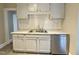 Kitchen with white cabinets, stainless steel dishwasher and dual basin sink at 2409 Shenandoah Ave, Durham, NC 27704