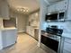 Modern kitchen featuring stainless steel appliances, white cabinets, and a subway tile backsplash at 2409 Shenandoah Ave, Durham, NC 27704