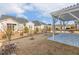 Spacious backyard with black metal fencing and a white pergola, offering privacy and style at 244 Bevis Marks Dr, Fuquay Varina, NC 27526
