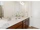 Bathroom features dual sinks, a large mirror, and neutral paint scheme at 244 Bevis Marks Dr, Fuquay Varina, NC 27526