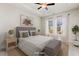This staged bedroom has a tray ceiling, comfortable layout, and lots of natural light at 244 Bevis Marks Dr, Fuquay Varina, NC 27526